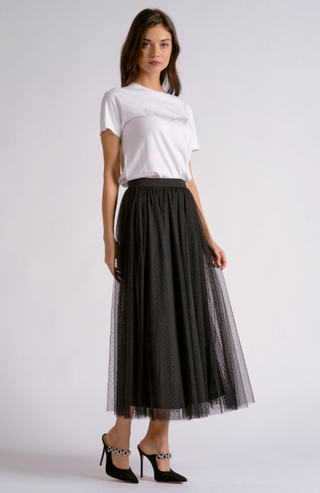 woman wearing sheer black dot mid length Skirt.