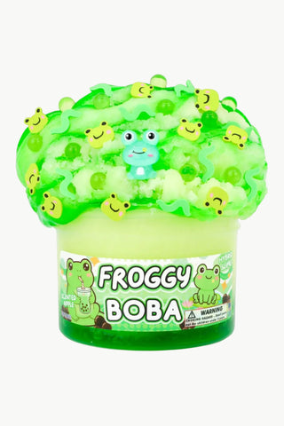 Green bubble tea with frog-shaped boba pearls on a white background