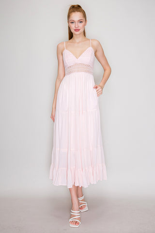 Iris Womens Clothing. Woman wearing a light pink dress.