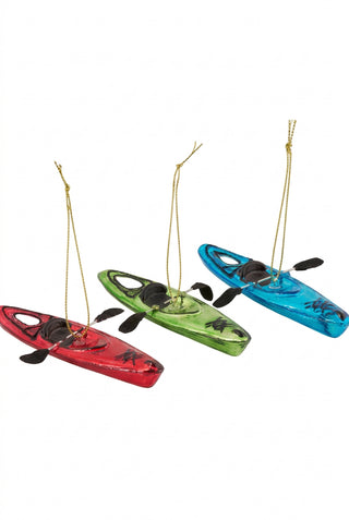 Three small hanging kayak ornaments in red, green, and blue, each with a gold hanging string and black paddle details, shown on a plain white background.