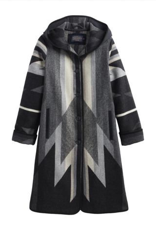 A long hooded coat with a geometric pattern in black, gray, and off-white, featuring a button-front closure and side pockets.