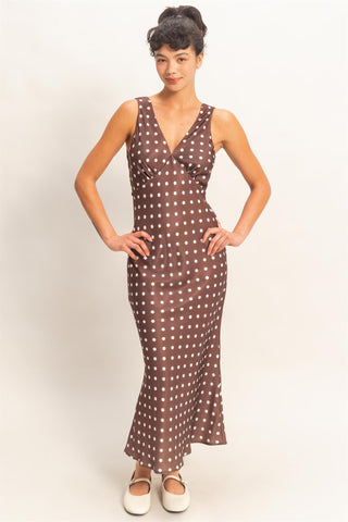 Woman wearing a brown polka dot dress.